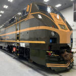 Olive green locomotive with yellow striping