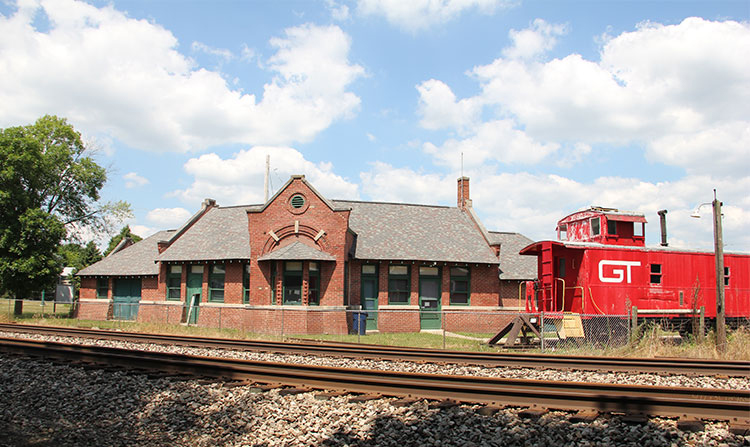 Train station with caboose next to tracks