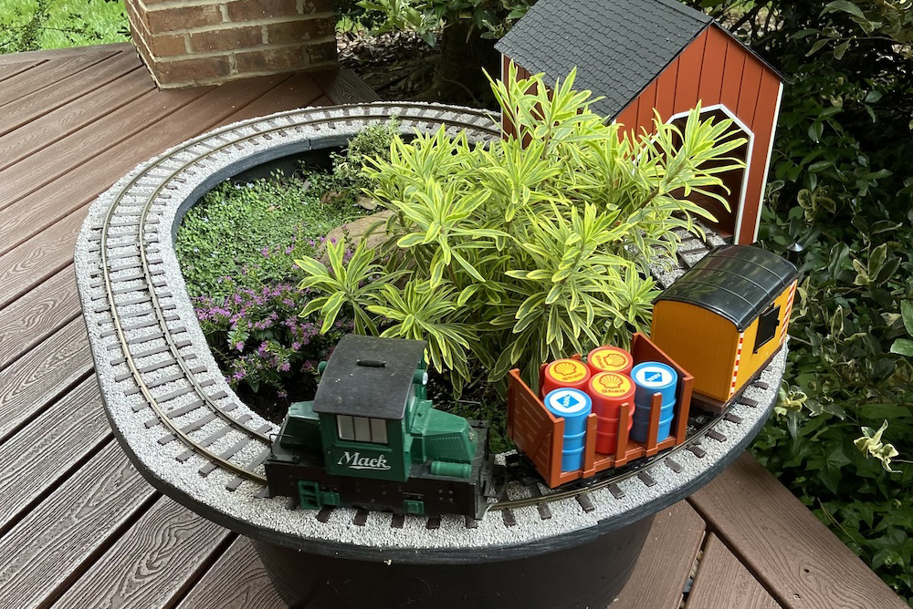 small planter with track, plants, and train