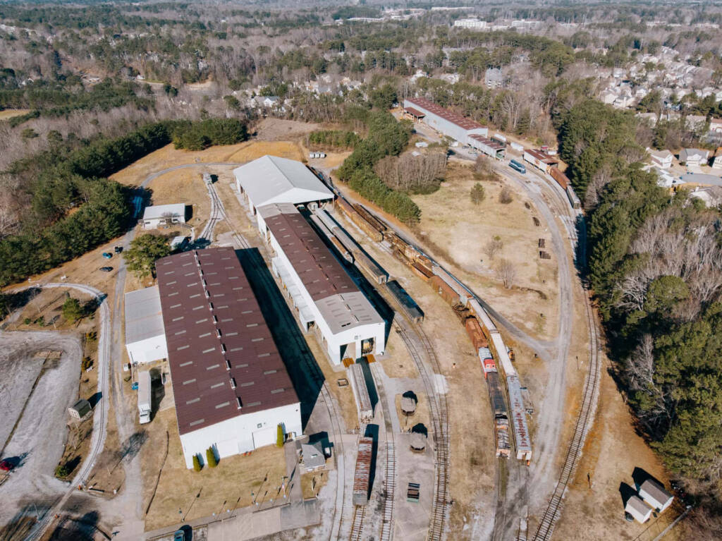 Aerial view of museum grounds with several buildings and strings of equipment outdoors