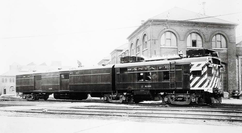 Motorcar in front of brick station