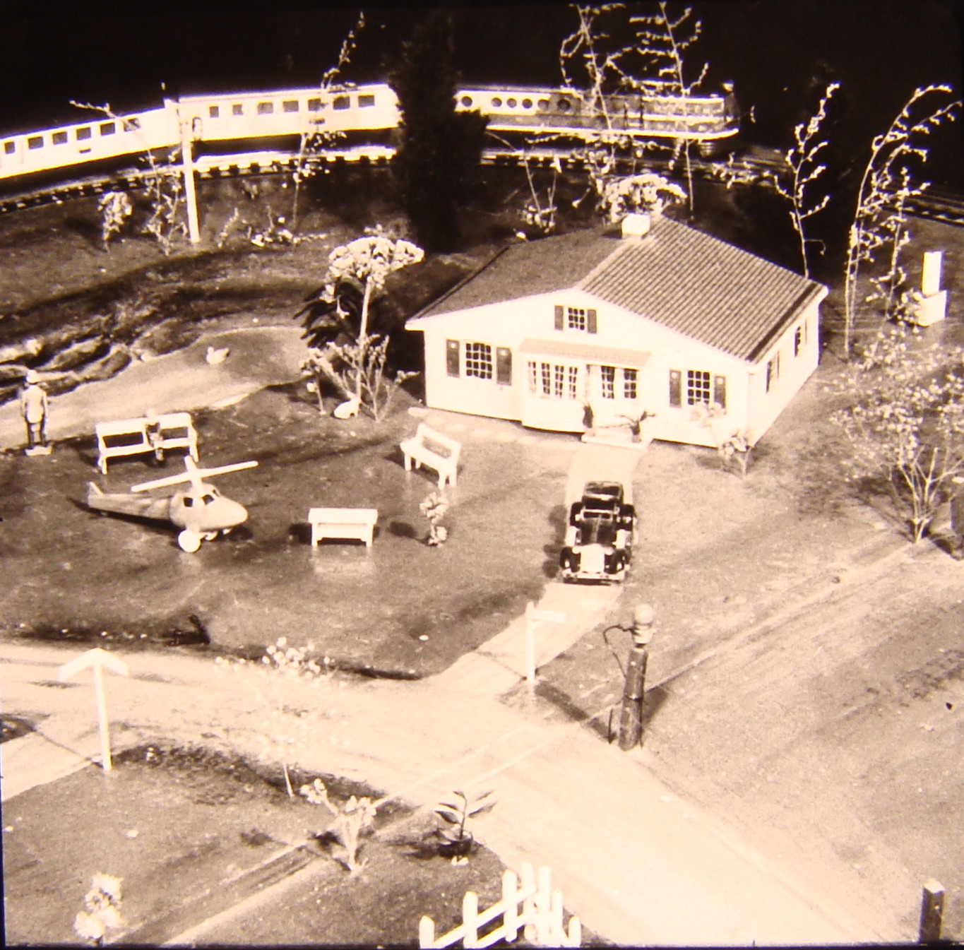 Black and white image on toy train layout with farm