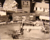Black and white image on toy train layout with sheep corral