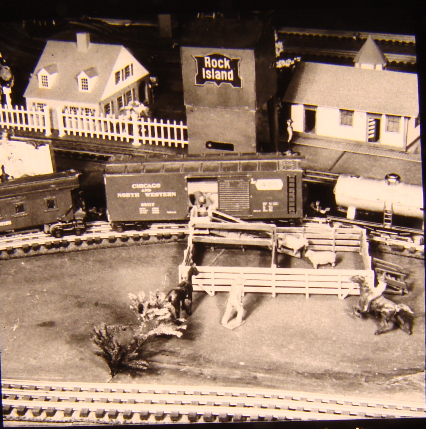 Black and white image on toy train layout with sheep corral