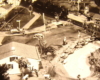 Black and white image on toy train layout with a lake
