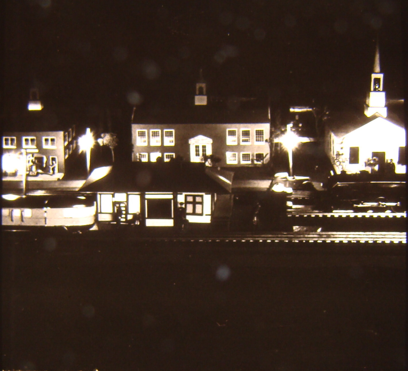 Black and white image on toy train layout of night scene