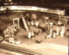 Black and white image on toy train layout with park