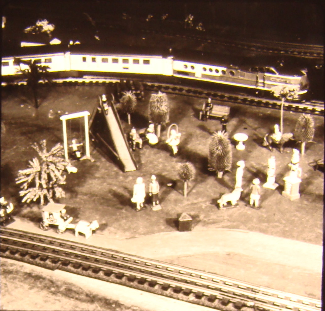 Black and white image on toy train layout with park