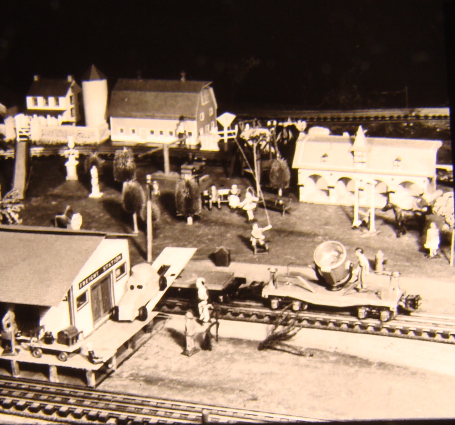 Black and white image on toy train layout with siding