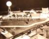Black and white image on toy train layout with farm and windmill