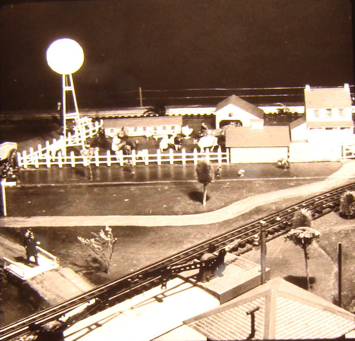 Black and white image on toy train layout with farm and windmill
