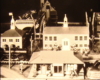 Black and white image of toy train layout with station