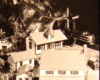 Black and white image on toy train layout with tunnel and town