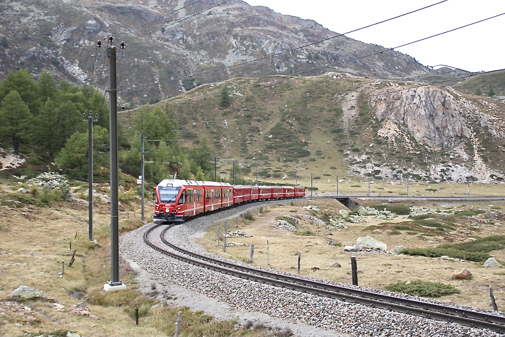 Red passenger train on curve