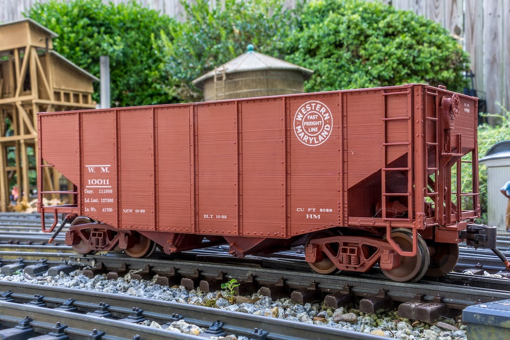 side view of maroon hopper car