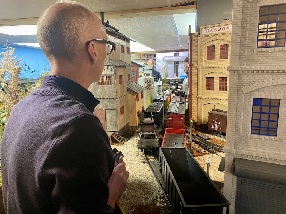 Behind-the-scenes of an operator switching cars on a layout.