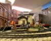 Scratch-built buildings in front of a curving main line