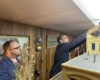 Two people set up a GoPro video camera.