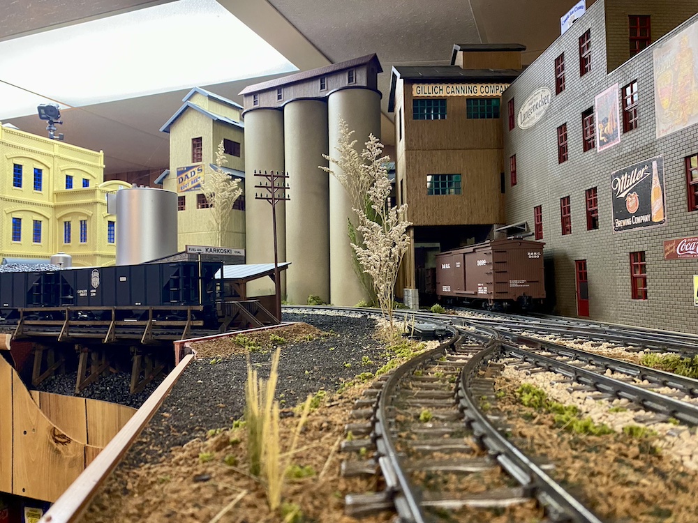 Main line with multiple industries in the background.