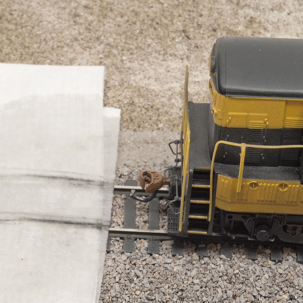 Color photo showing HO scale diesel by white paper towel with streaks of dirt on it.