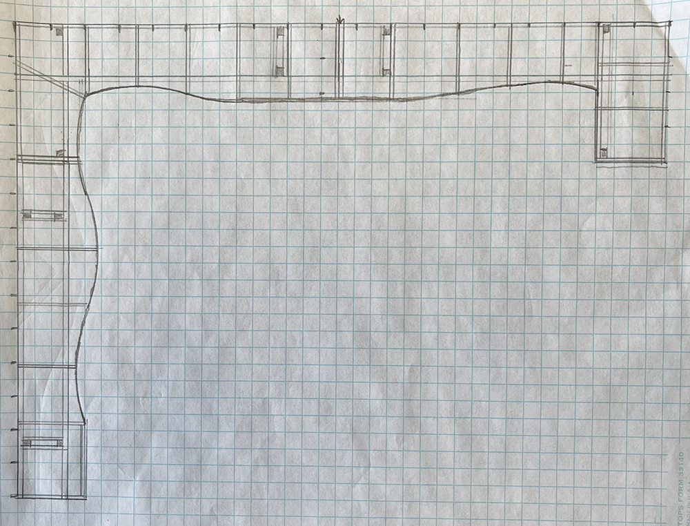 Paper and pencil drawing showing lines for framing sections on a model railroad placed on graph paper with light blue lines.