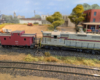 An HO scale GP7 shoving a caboose