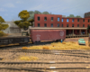An HO scale gondola and boxcar at an industry