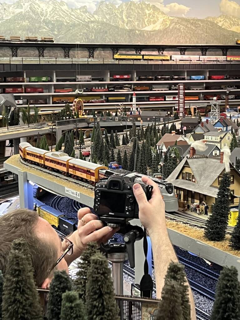 man adjusting camera