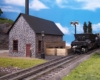 model boiler house with locomotive heading away
