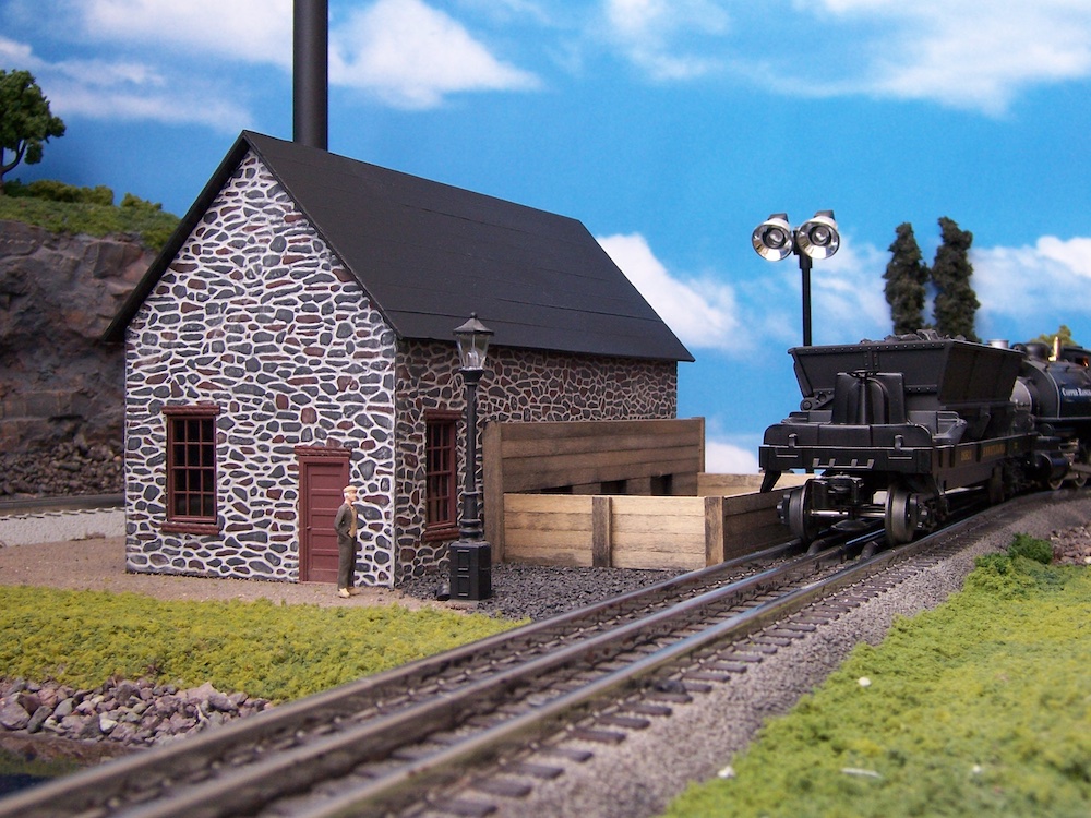 model boiler house with locomotive heading away