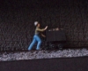  model figure pushing cart on train layout