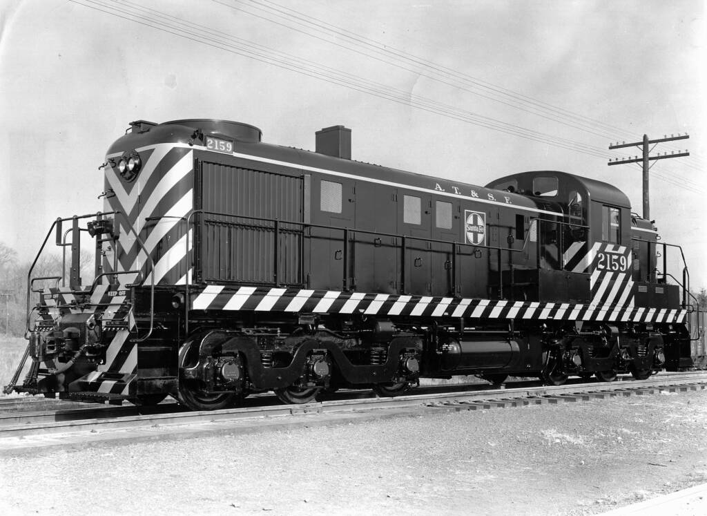 black and white image of diesel locomotive on track