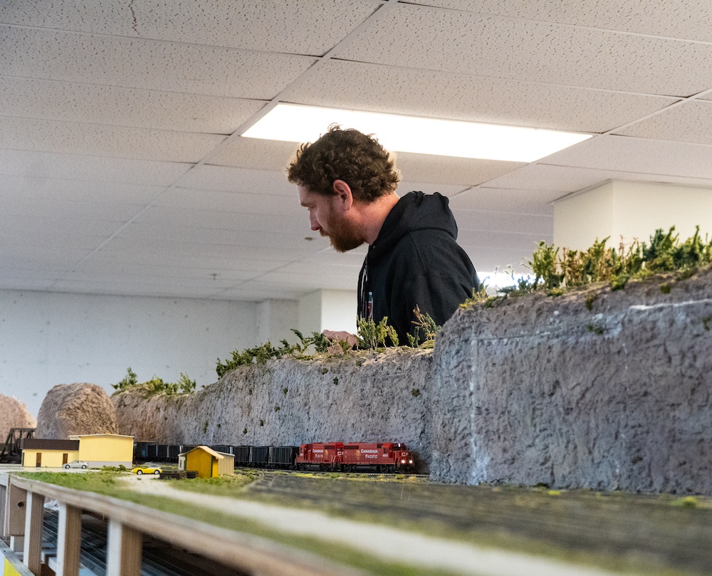 Model train traveling through scenery