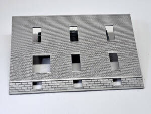 Piece of brick wall spraypainted light gray