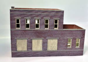 Two-story brick building with freight doors on the first floor