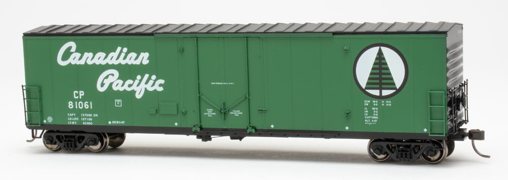 Color photo of HO scale boxcar painted green and black on white background