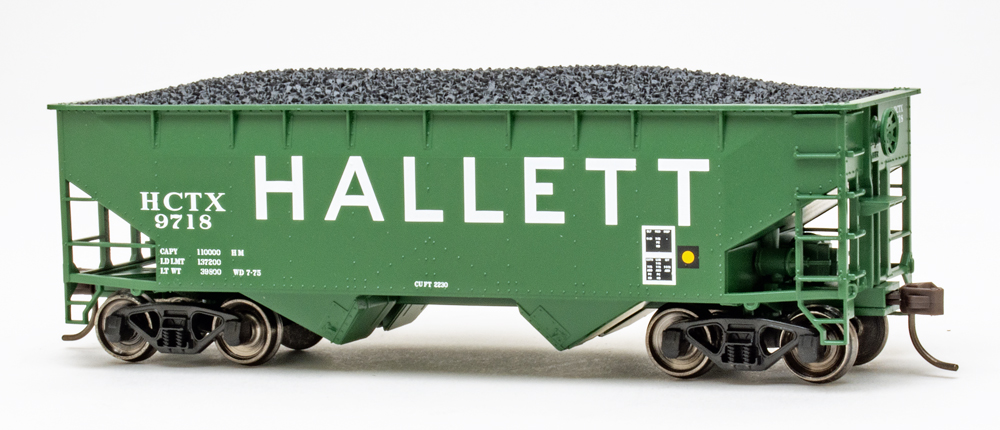 Color photo of HO scale two-bay offset-side hopper painted green with white graphics