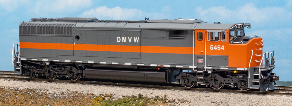 Color photo of orange and gray HO diesel on scenicked base
