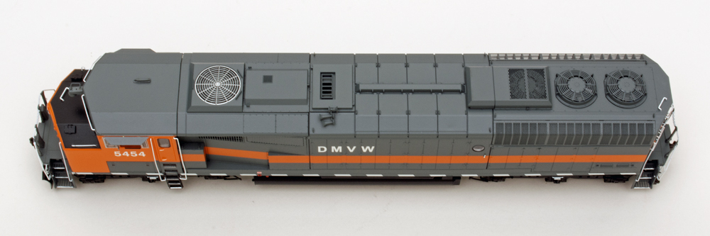 Color overhead view of HO scale diesel painted gray and orange on white background.