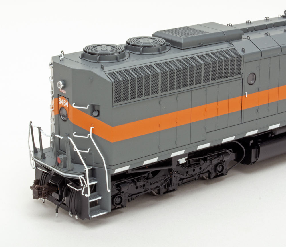 Color photo showing rear of HO diesel painted orange and gray on white background