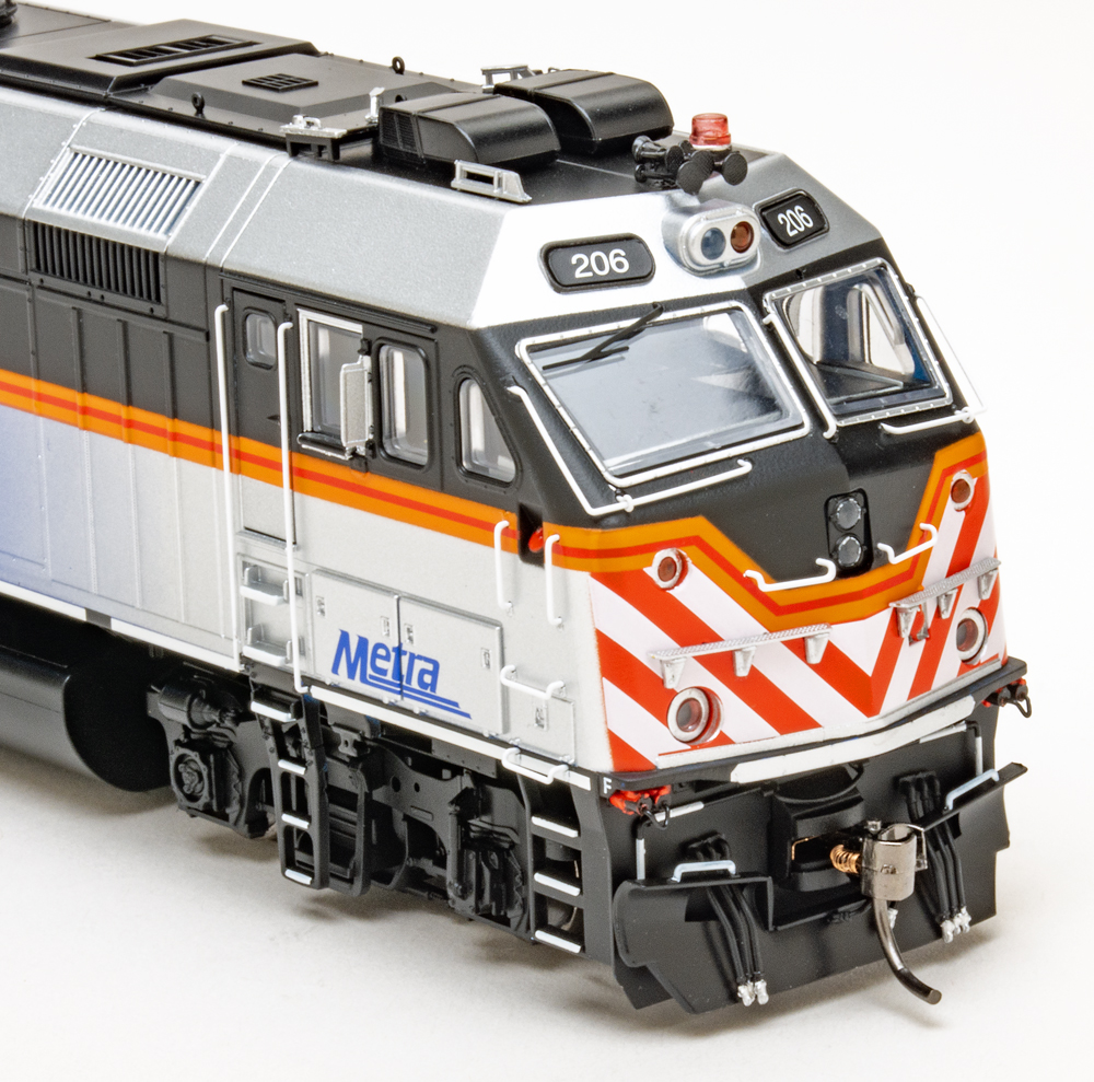 Color photo of HO scale commuter diesel on white background.