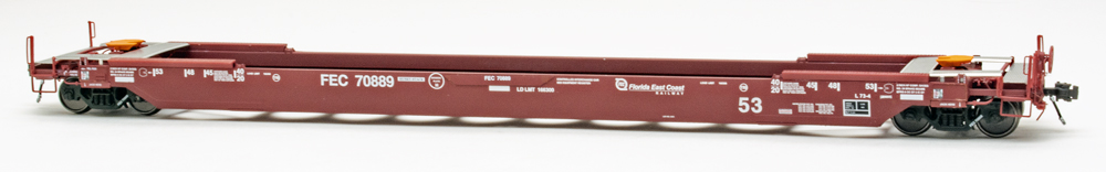 Color photo of HO scale well car painted red with white graphics