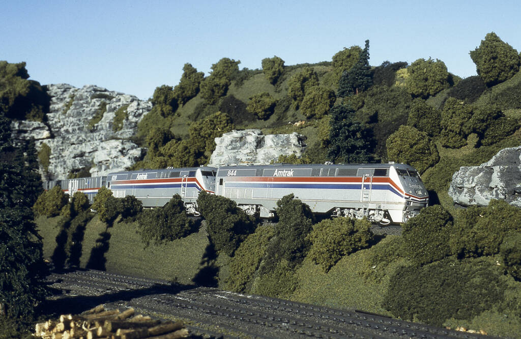 A silver Amtrak. model train on a model railroad layout