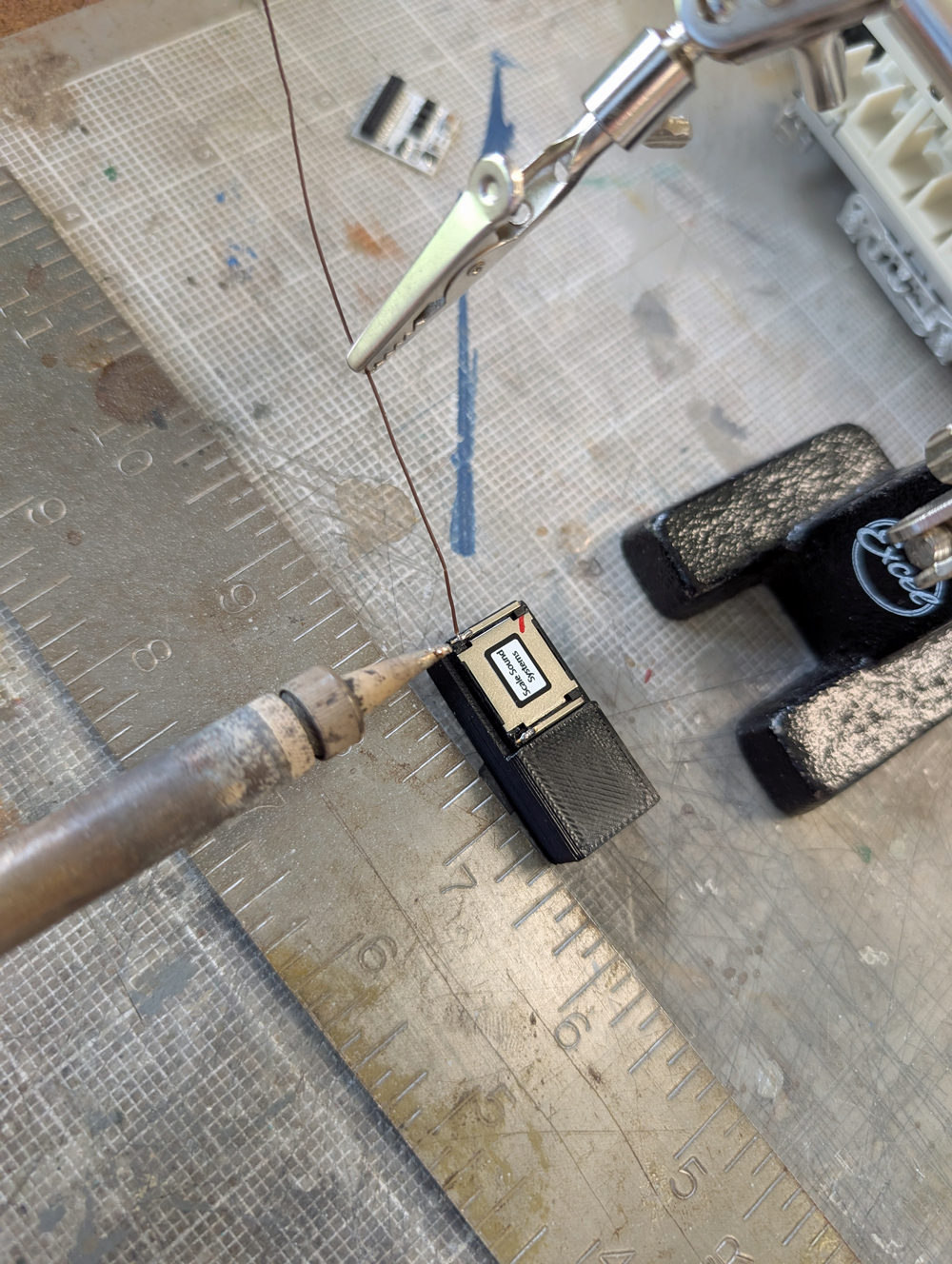 Soldering a wire to a model train speaker