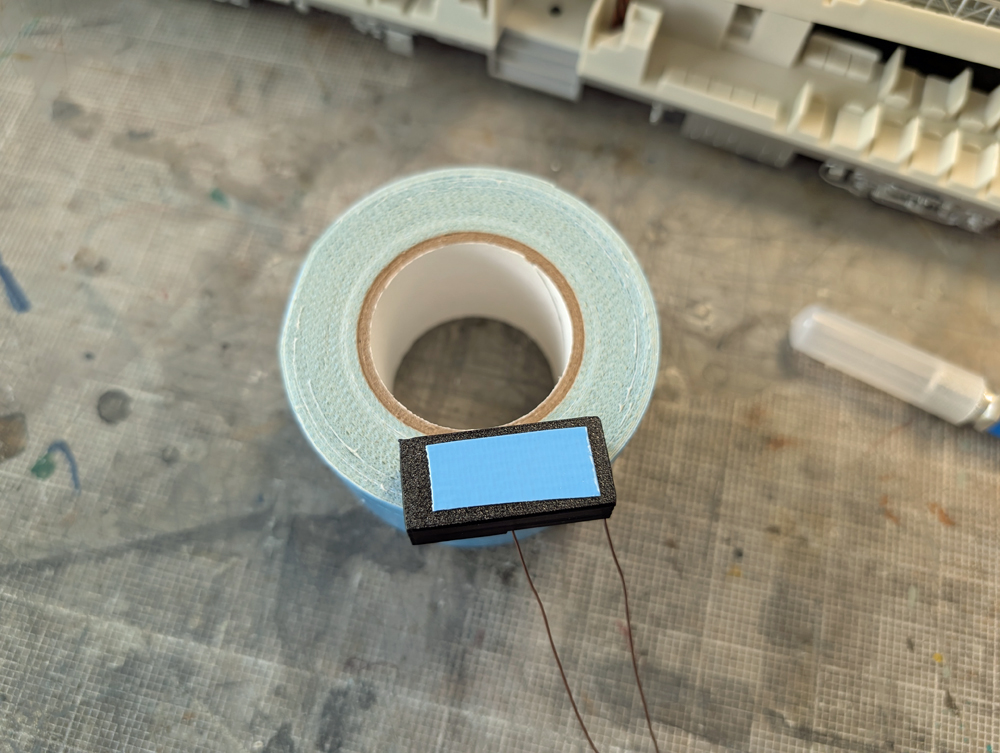 Double-sided tape on bottom of speaker housing