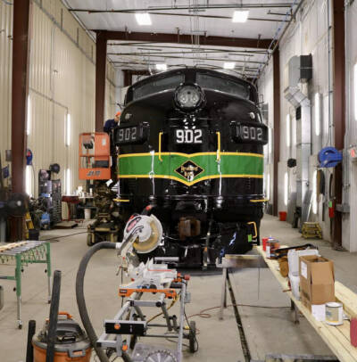 Diesel locomotive in shop bay for restoration.
