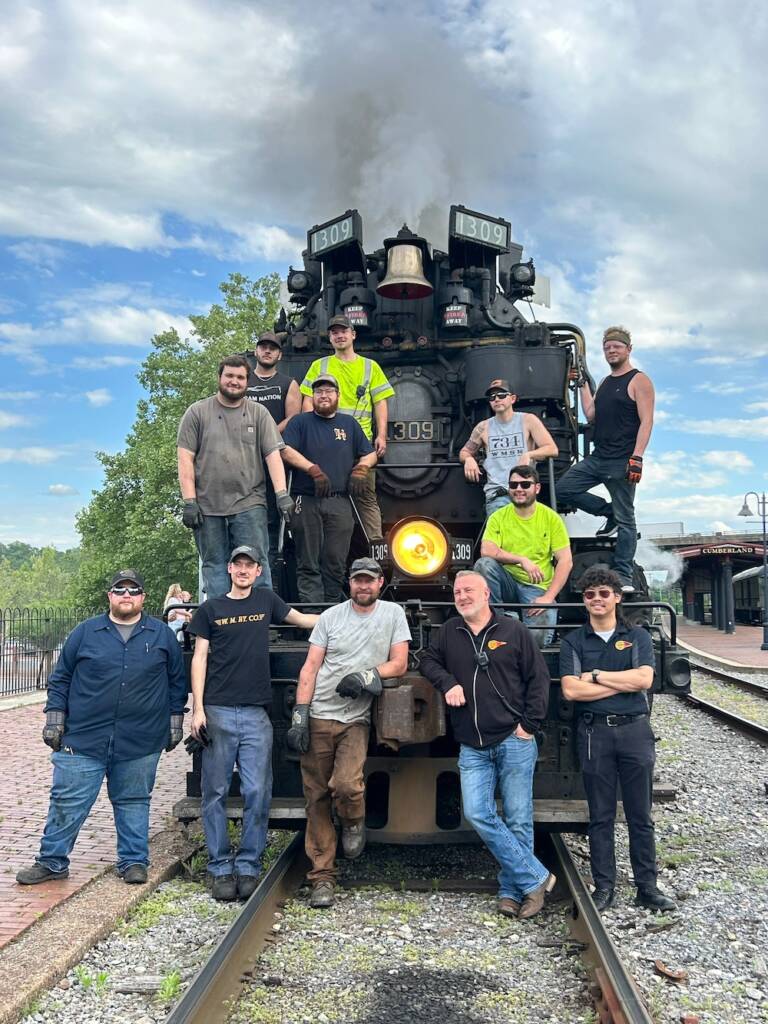 Crew photo in front of steam locomotive