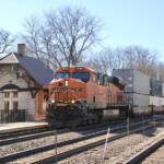 Intermodal train passing small station