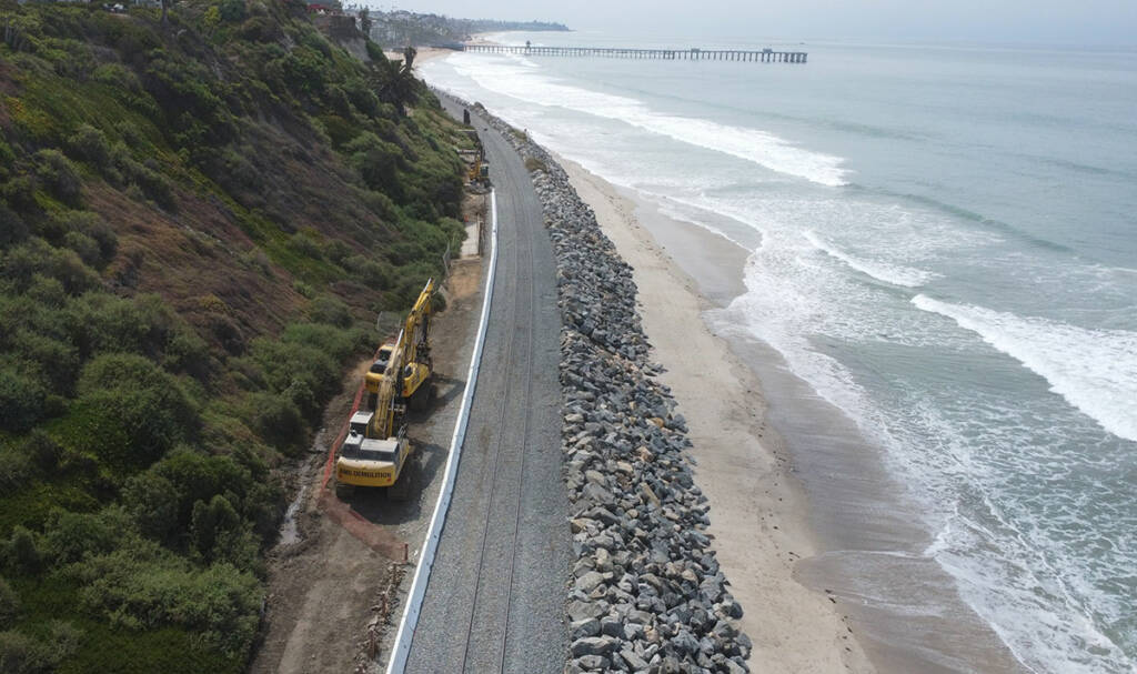 Aerial view of rail line with newly placed rocks to guard against coastal erosion