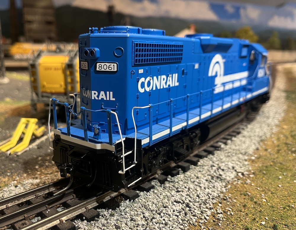 rear of a blue and white model locomotive